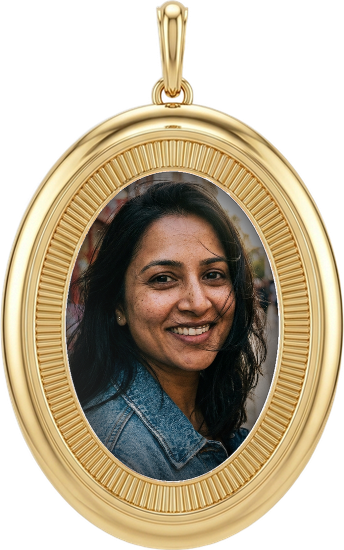 A portrait set into a gold locket charm